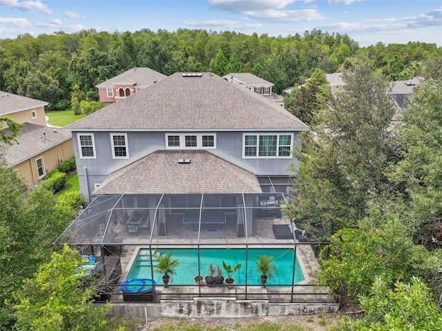 back of house with a lanai and a patio