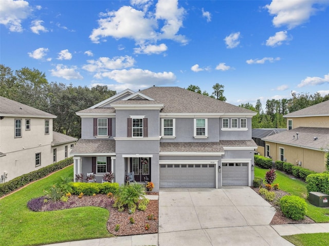 front of property with a garage, a porch, and a front lawn