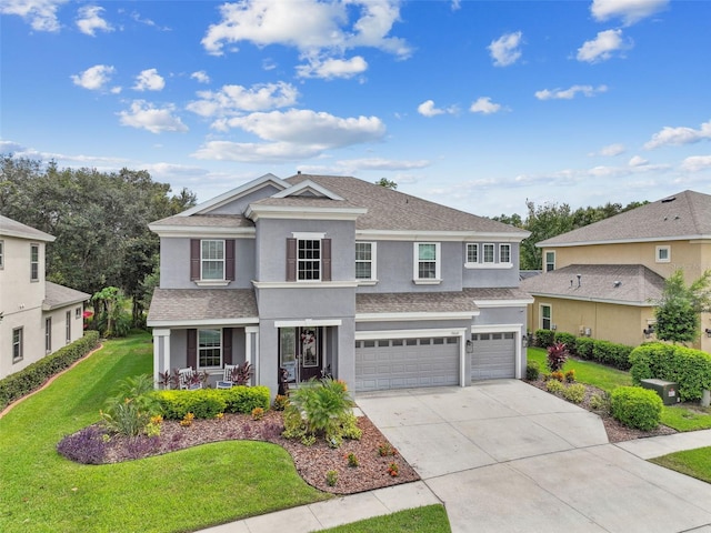 view of property featuring a garage, a porch, and a front yard