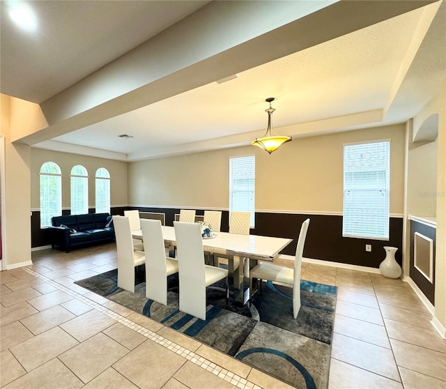 tiled dining space featuring plenty of natural light