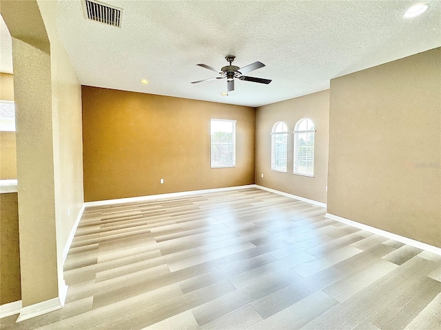 unfurnished room featuring ceiling fan, a textured ceiling, and light hardwood / wood-style floors