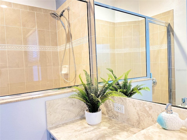 bathroom featuring a shower with door