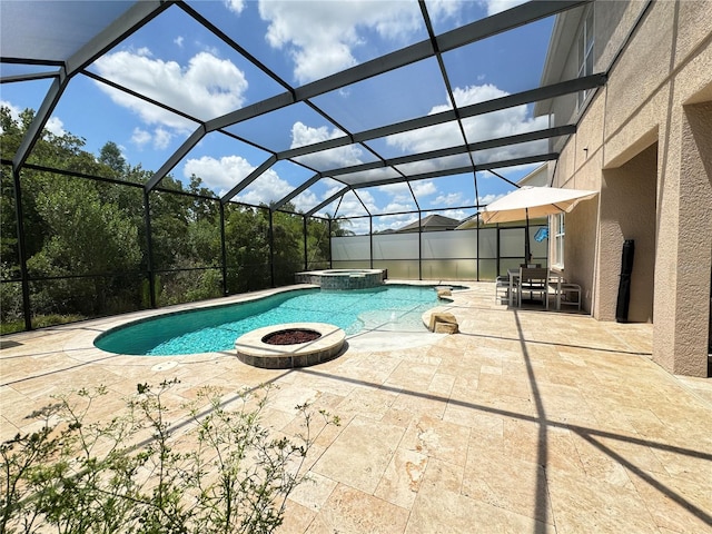 view of swimming pool featuring a lanai, a patio, and an in ground hot tub