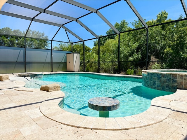 view of pool featuring an in ground hot tub, a lanai, and a patio