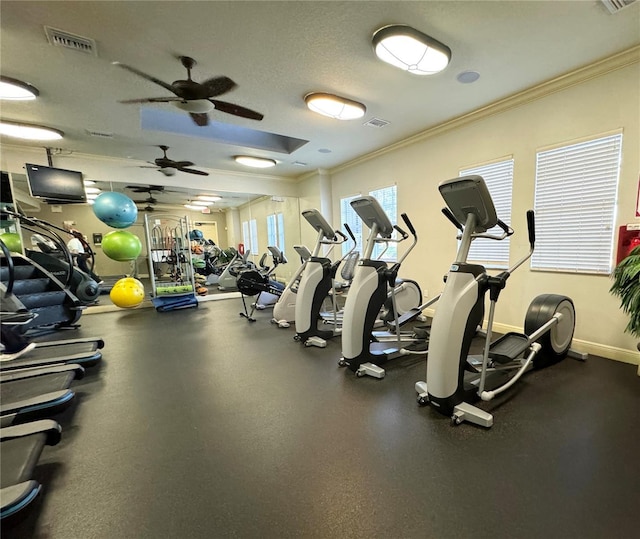 workout area with crown molding and a textured ceiling