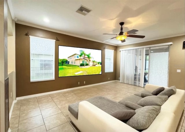 home theater room with light tile patterned flooring, ceiling fan, and ornamental molding