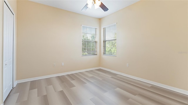 4110 Huntingdale Ct, Wesley Chapel, FL 33543 - unfurnished bedroom featuring light wood-type flooring, baseboards, a closet, and a ceiling fan