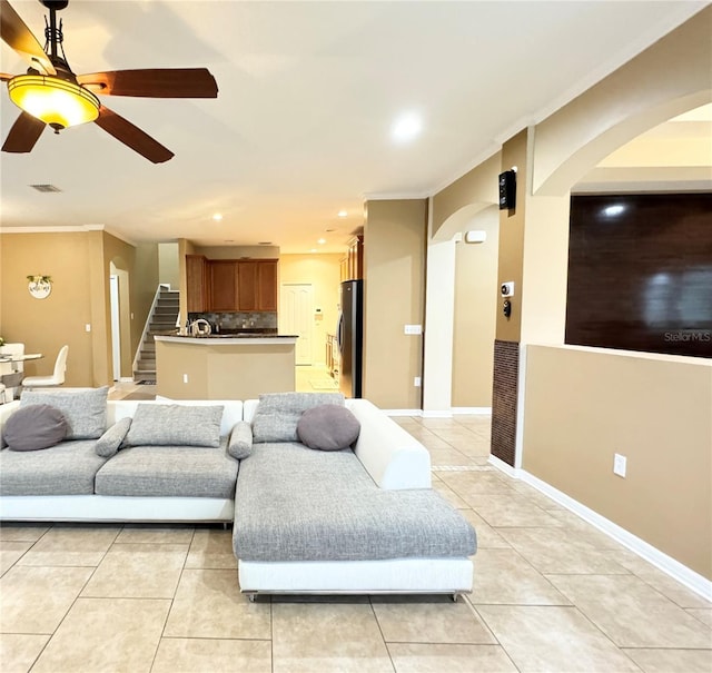 4110 Huntingdale Ct, Wesley Chapel, FL 33543 - living area with ornamental molding, arched walkways, light tile patterned floors, stairway, and recessed lighting