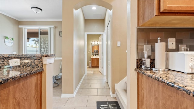 4110 Huntingdale Ct, Wesley Chapel, FL 33543 - bathroom featuring tile patterned floors, ornamental molding, backsplash, and baseboards