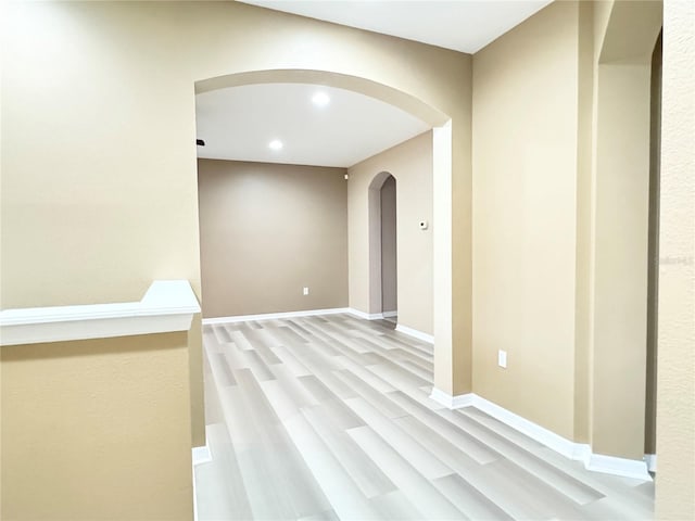 4110 Huntingdale Ct, Wesley Chapel, FL 33543 - hallway featuring arched walkways, recessed lighting, light wood-style flooring, and baseboards