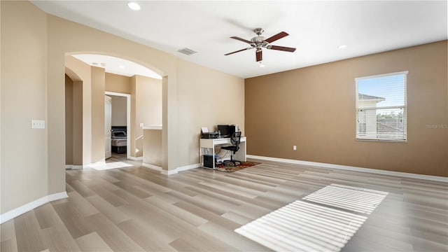 4110 Huntingdale Ct, Wesley Chapel, FL 33543 - office space featuring arched walkways, light wood-type flooring, ceiling fan, recessed lighting, and baseboards