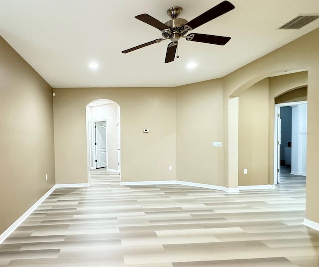 4110 Huntingdale Ct, Wesley Chapel, FL 33543 - empty room featuring arched walkways, a ceiling fan, light wood finished floors, recessed lighting, and baseboards