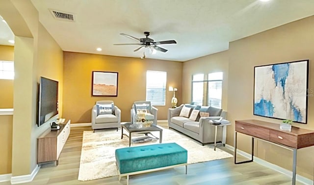 4110 Huntingdale Ct, Wesley Chapel, FL 33543 - living area featuring baseboards, light wood finished floors, a ceiling fan, arched walkways, and recessed lighting