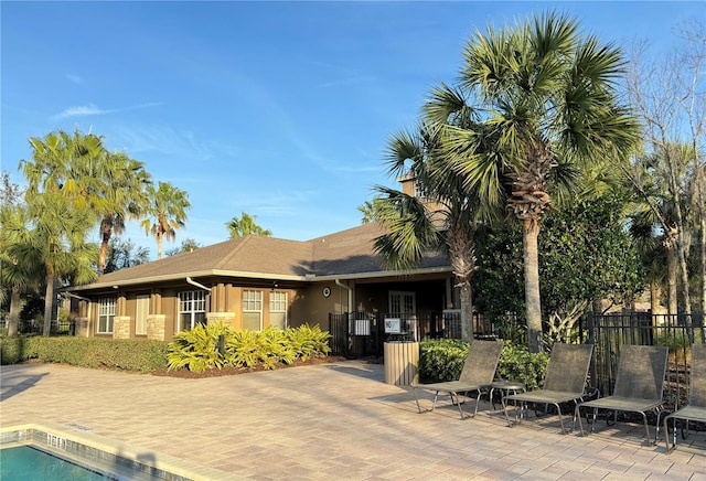 4110 Huntingdale Ct, Wesley Chapel, FL 33543 - rear view of property featuring stucco siding and a patio area