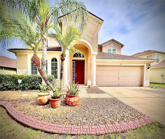 4110 Huntingdale Ct, Wesley Chapel, FL 33543 - mediterranean / spanish house featuring stucco siding, an attached garage, and concrete driveway