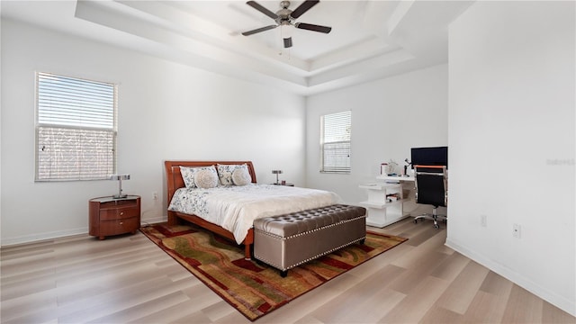 4110 Huntingdale Ct, Wesley Chapel, FL 33543 - bedroom with a raised ceiling, light wood-style flooring, a desk, and baseboards