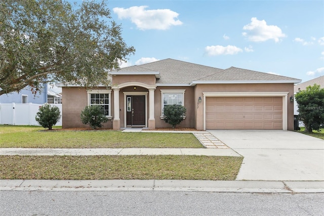 view of front of home featuring a garage and a front lawn