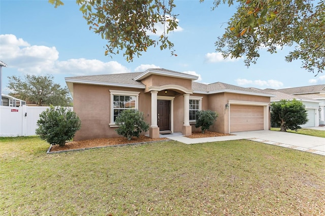 view of front facade with a garage and a front lawn