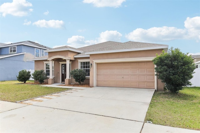 view of front of house with a garage and a front lawn