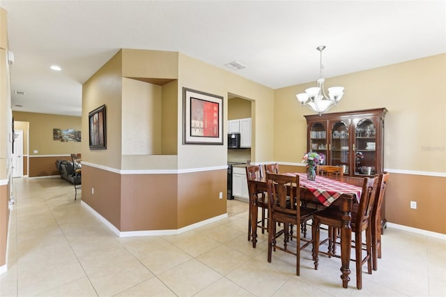 dining room featuring a notable chandelier and light tile patterned floors