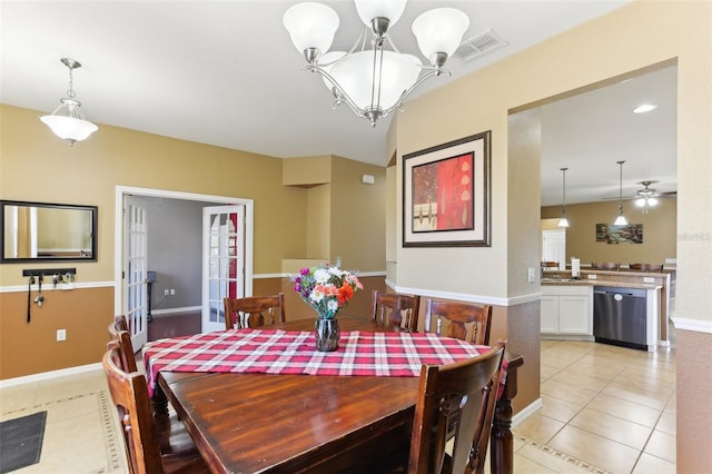 tiled dining space featuring an inviting chandelier