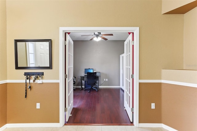 corridor with french doors and hardwood / wood-style flooring