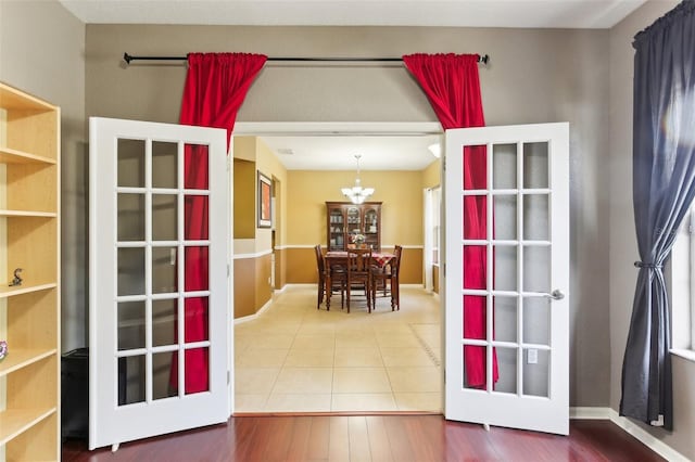 interior space with an inviting chandelier and french doors