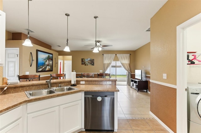 kitchen with washer / dryer, sink, dishwasher, pendant lighting, and white cabinets