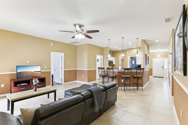 tiled living room with ceiling fan