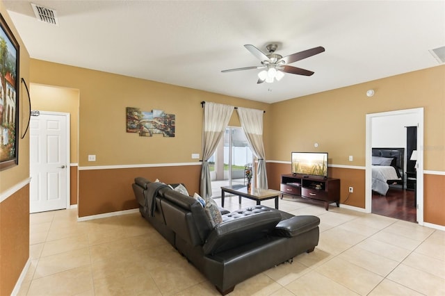 tiled living room featuring ceiling fan