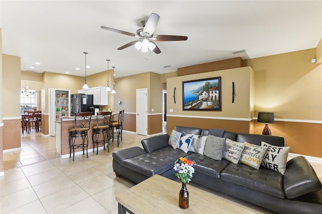 living room with light tile patterned floors and ceiling fan