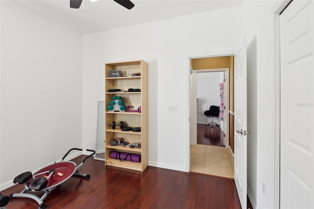 exercise room with dark hardwood / wood-style floors and ceiling fan