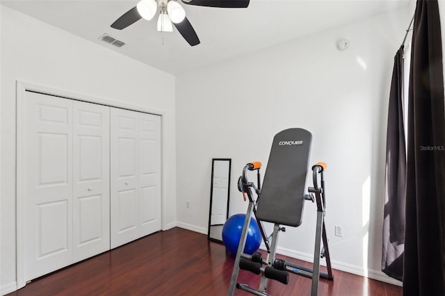 workout room with dark hardwood / wood-style floors and ceiling fan