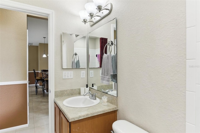 bathroom featuring vanity, tile patterned floors, and toilet