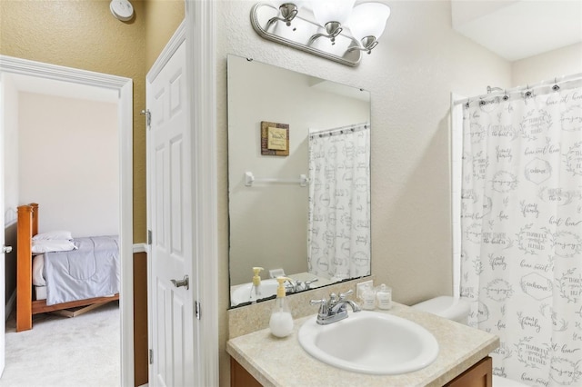 bathroom featuring vanity, toilet, and curtained shower