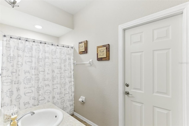 bathroom with a shower with curtain and sink