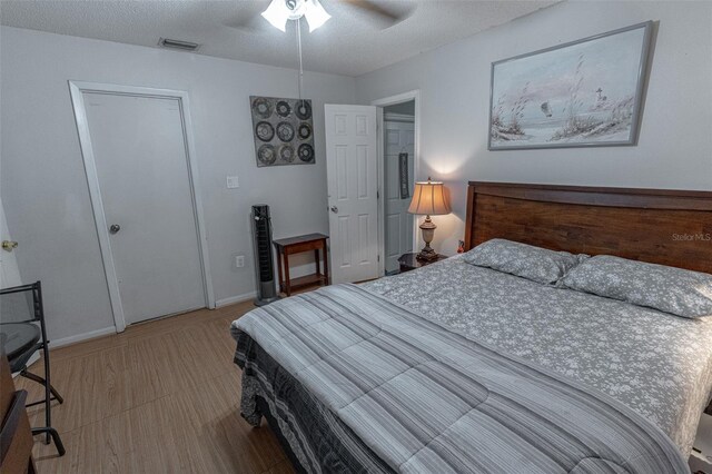 bedroom with ceiling fan and a textured ceiling