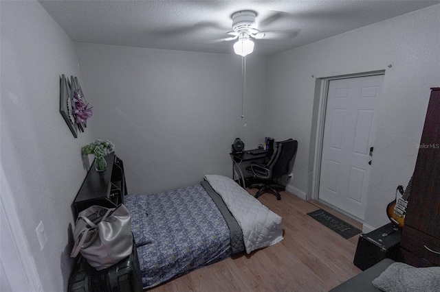 bedroom with ceiling fan and wood-type flooring