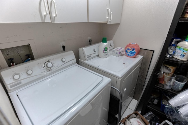 laundry area with cabinets and washer and clothes dryer