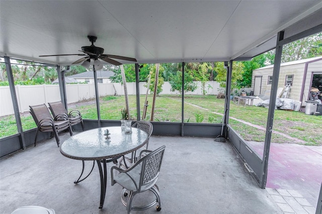 sunroom featuring ceiling fan