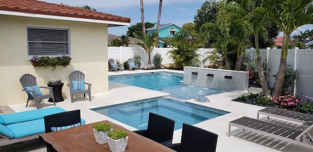 view of pool with a patio and an in ground hot tub