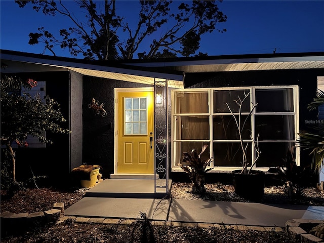 view of exterior entry at night