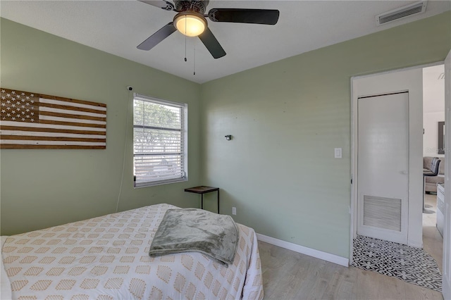 bedroom with light hardwood / wood-style flooring and ceiling fan