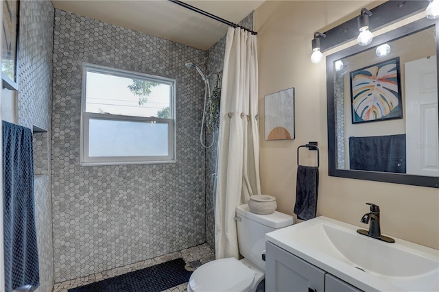 bathroom featuring walk in shower, vanity, and toilet