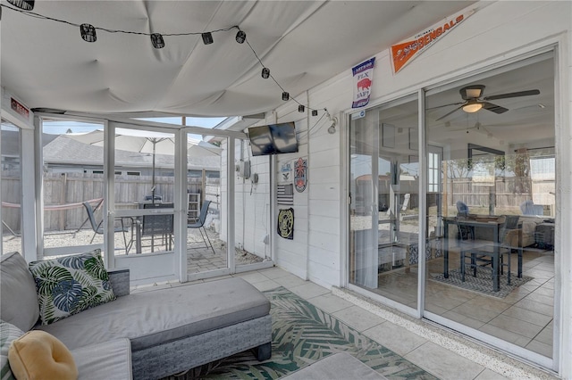 sunroom featuring ceiling fan