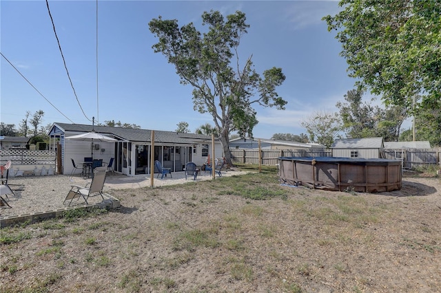 view of yard with a fenced in pool and a patio area