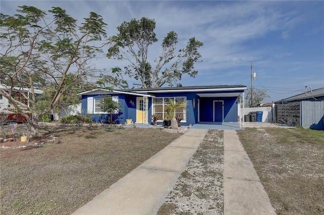 view of front of house with a carport and driveway