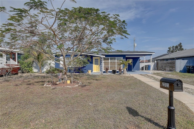 view of front of home featuring a carport, fence, and driveway