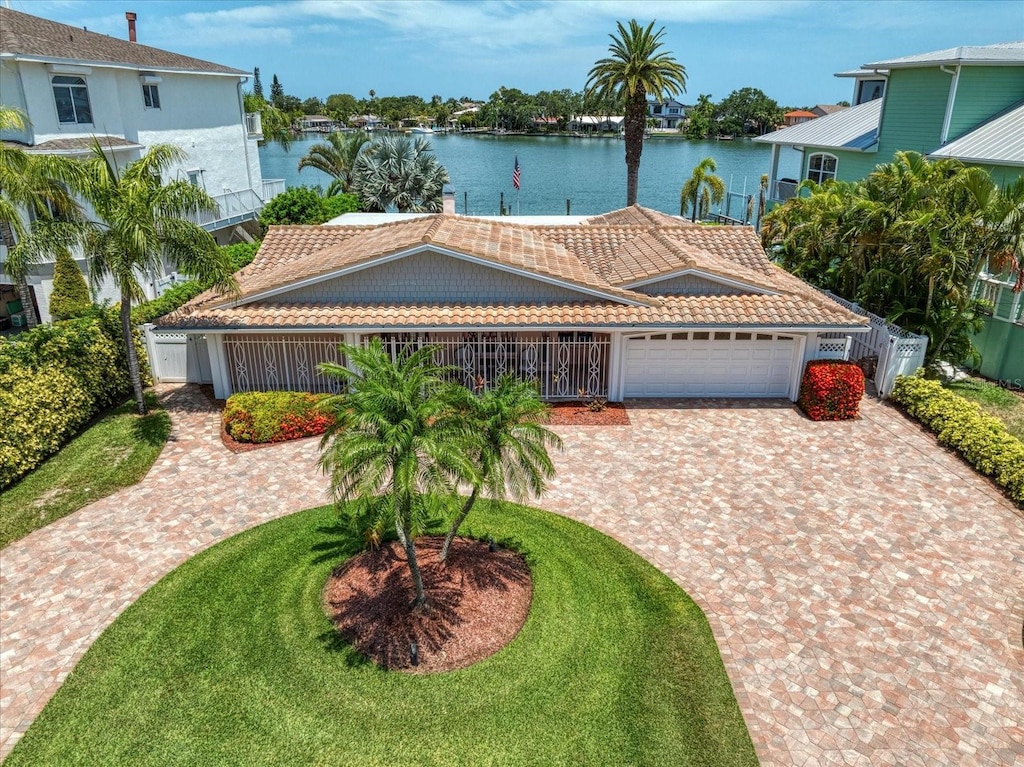 view of front of property with a garage and a water view