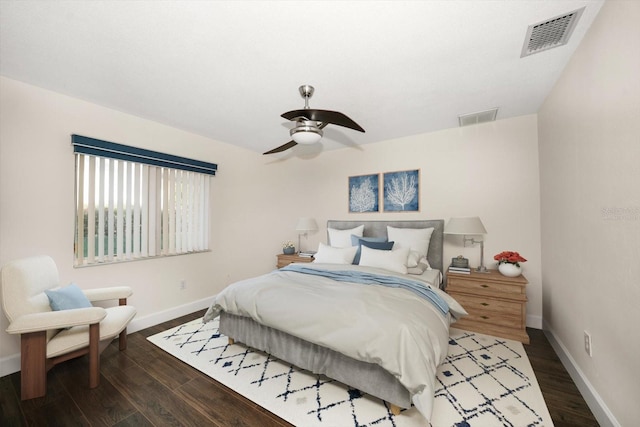 bedroom with dark hardwood / wood-style floors and ceiling fan